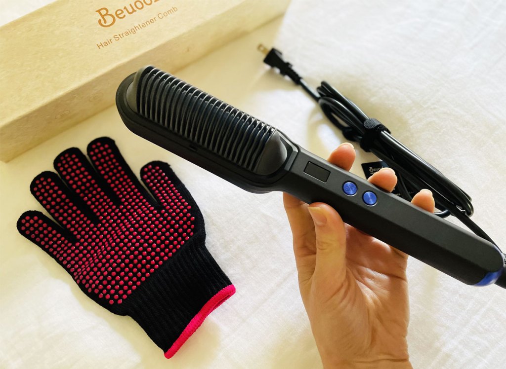 hand holding hair straightener brush