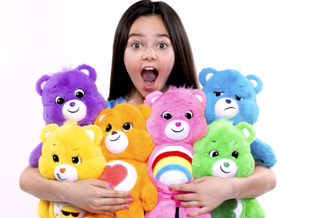 Girl holding Care Bear plush