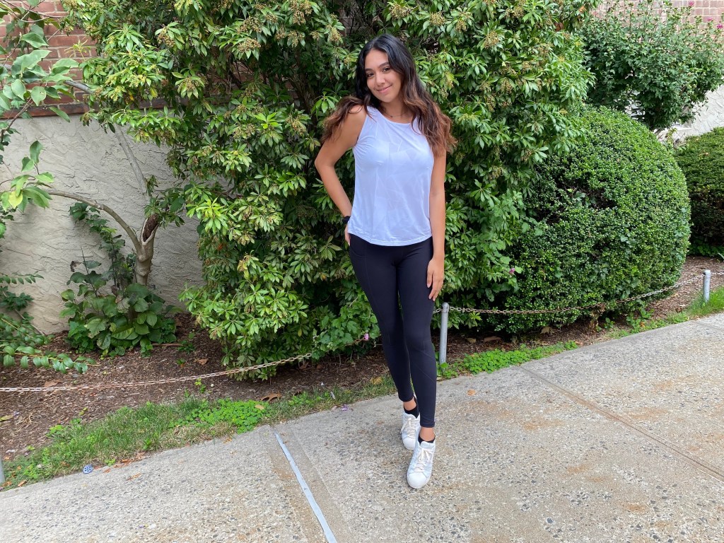 woman wearing blue tank and black leggings