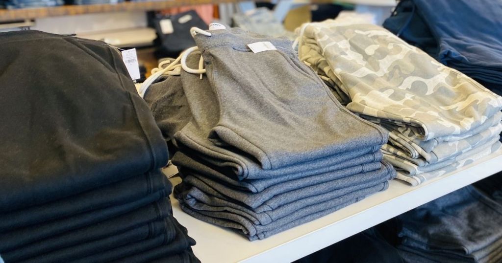 row of folded joggers on a table