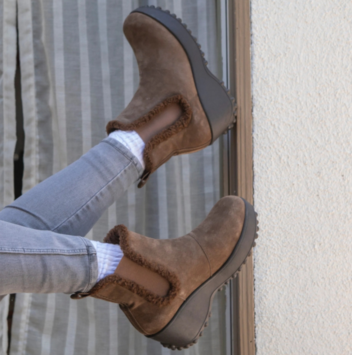 Person wearing a pair of brown Rocket Dog boots