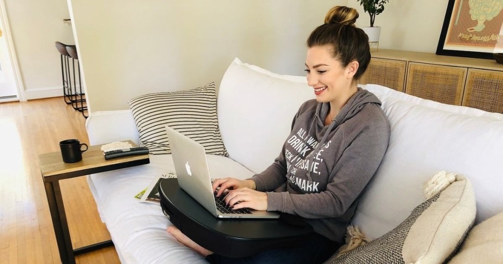 woman using Macbook on couch