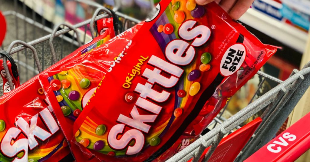 hand grabbing red bag of candy 