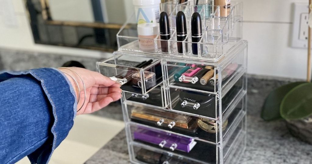 hand opening a drawer on a makeup organizer