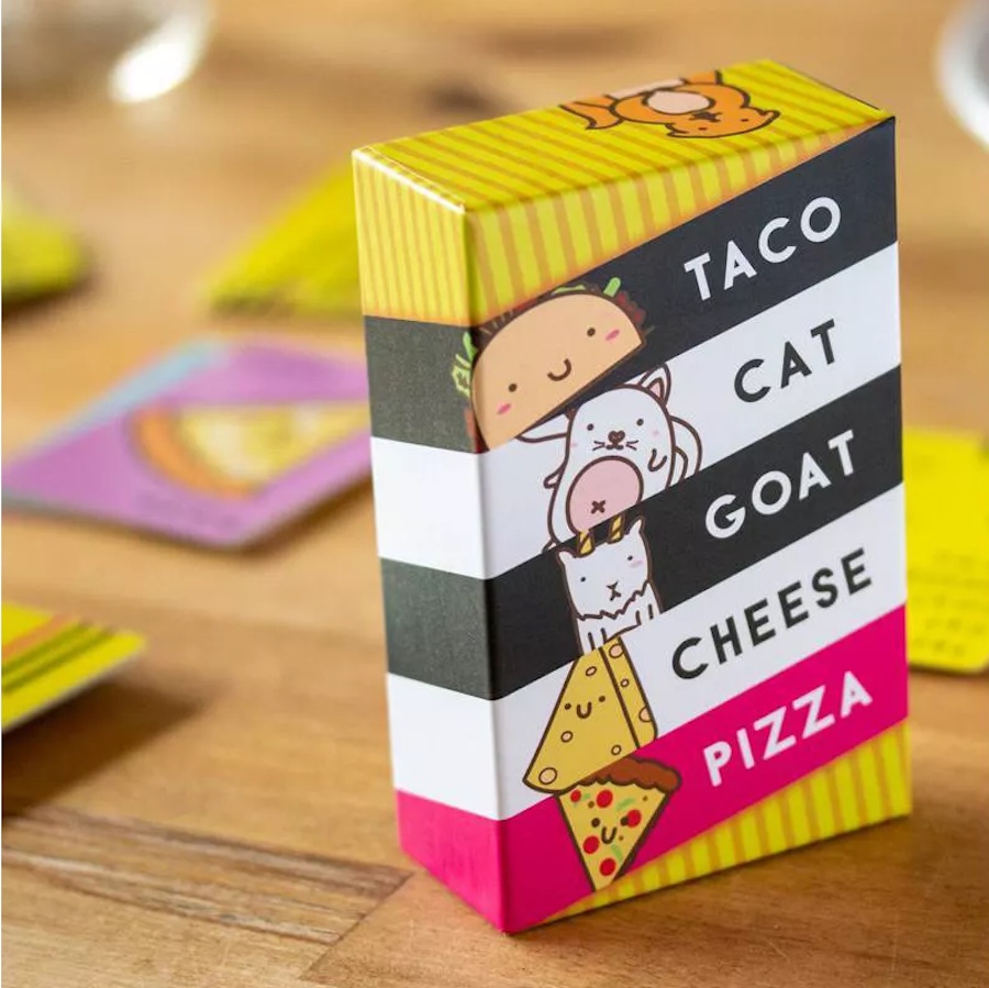 Taco Cat goat cheese pizza Game box and cards on a table
