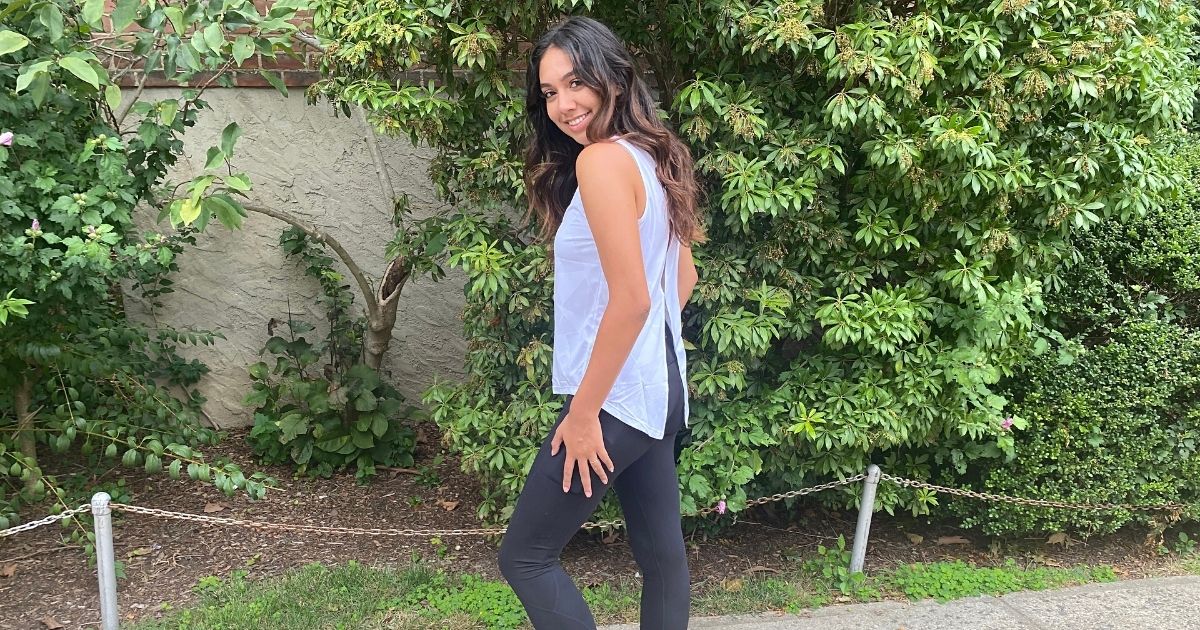woman wearing white tank and black leggings