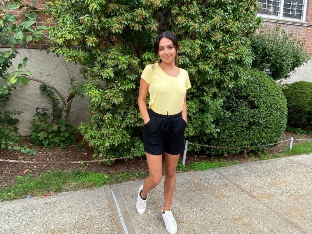 woman wearing yellow shirt and black shorts
