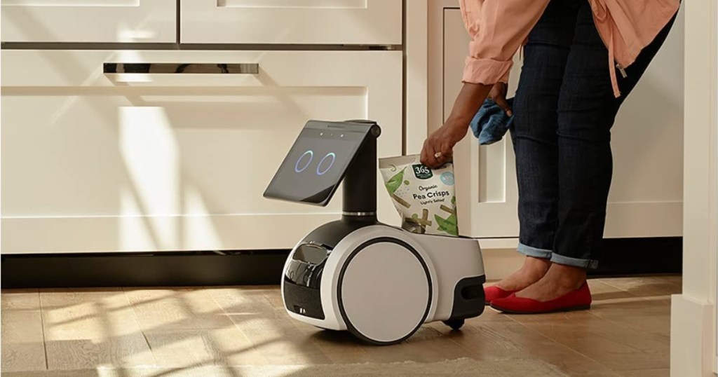 woman adding bag to household robot