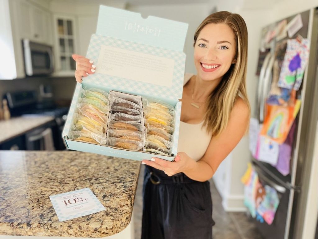 woman holding box of Cheryl's cookies