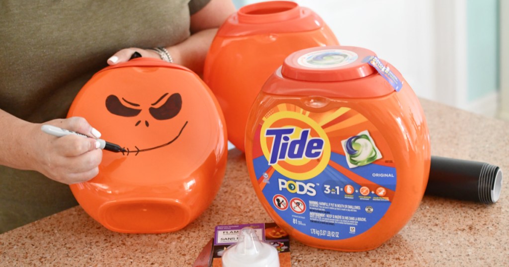drawing pumpkin face on tide pod container