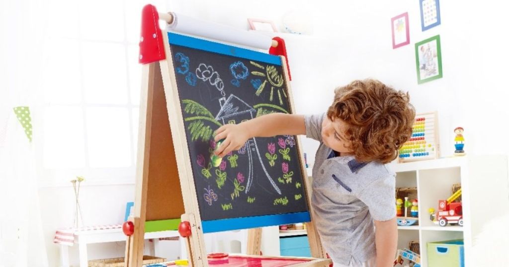 kid drawing on an art easel