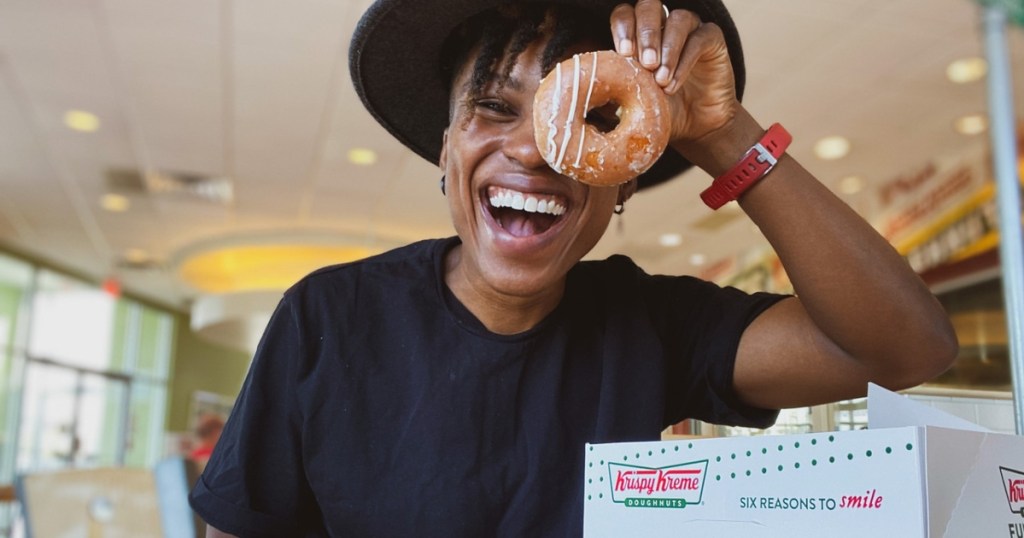 peeking through the hole of a Krispy Kreme doughnut