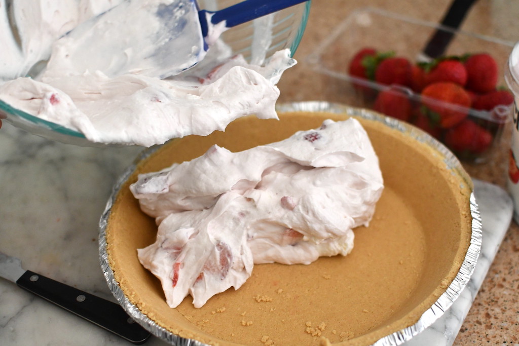 making yogurt cream pie and putting it in graham cracker crust