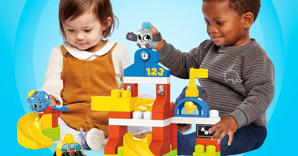 2 little toddlers playing with mega blocks