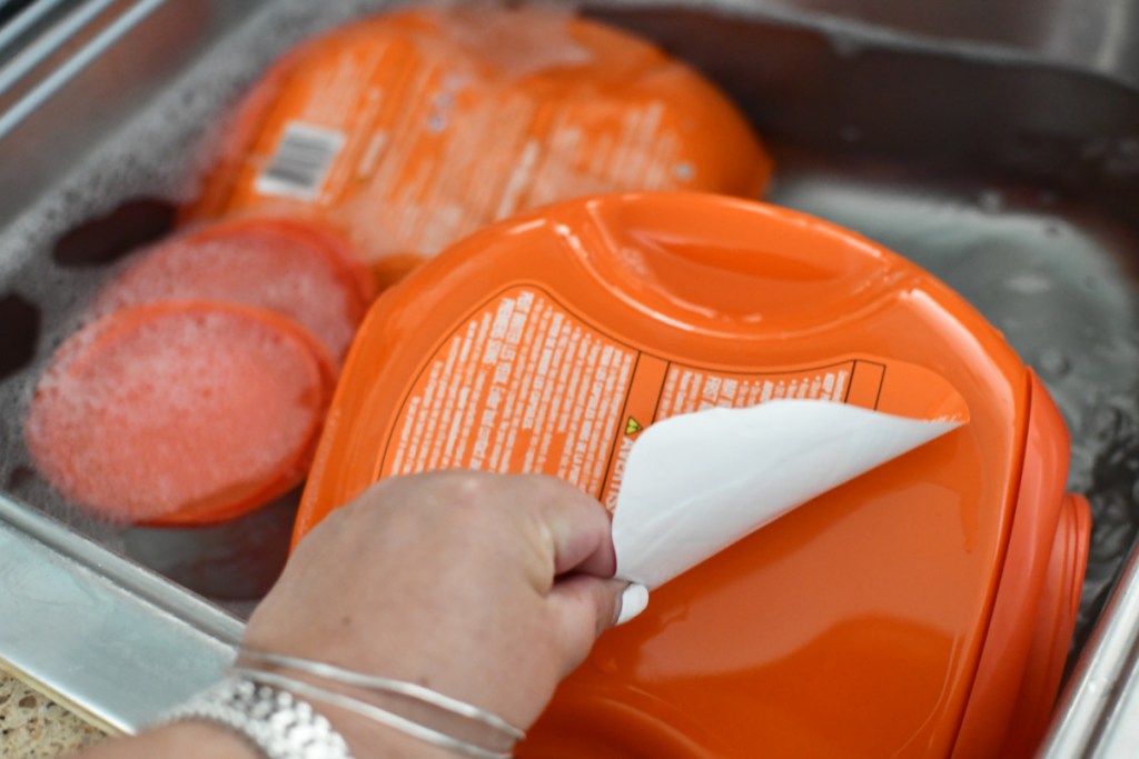 peeling the label off tide pods container