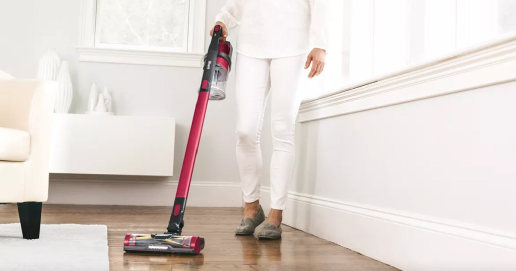 woman holding shark rocket vacuum