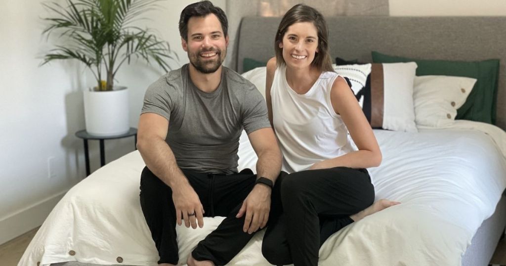 Man and woman sitting on a bed together