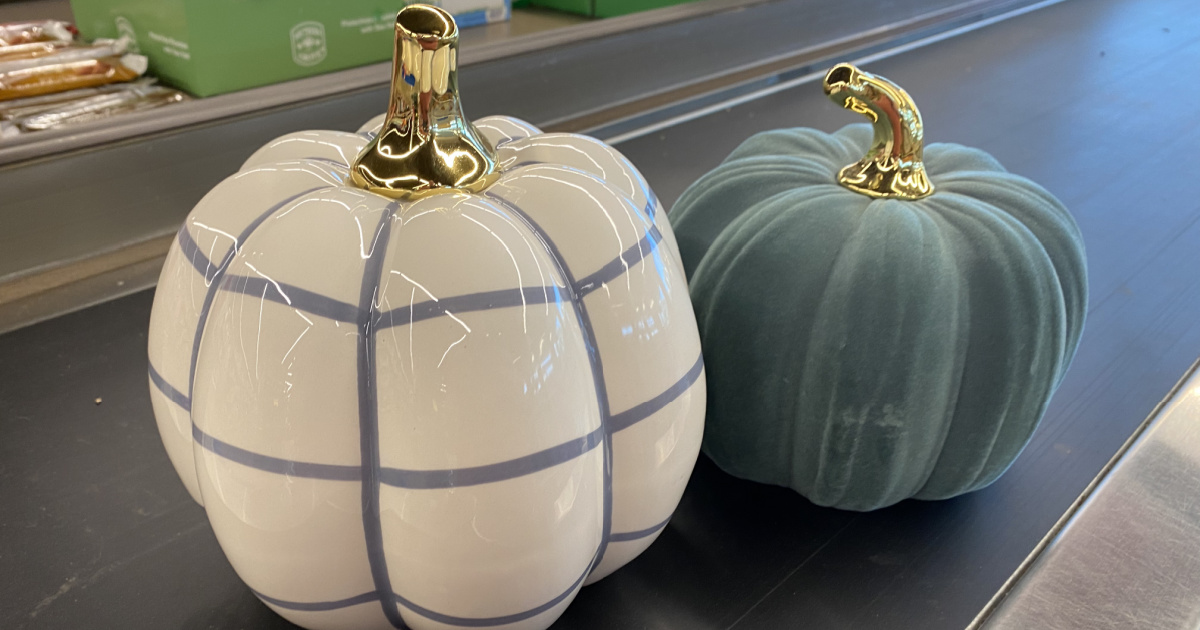two ceramic pumpkins on conveyor belt