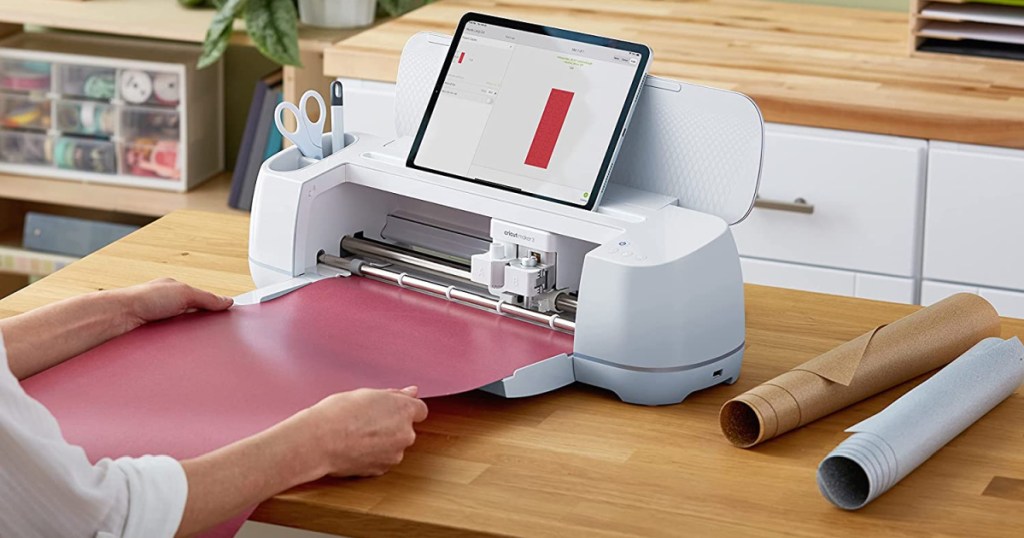 woman putting red glitter vinyl into Cricut machine