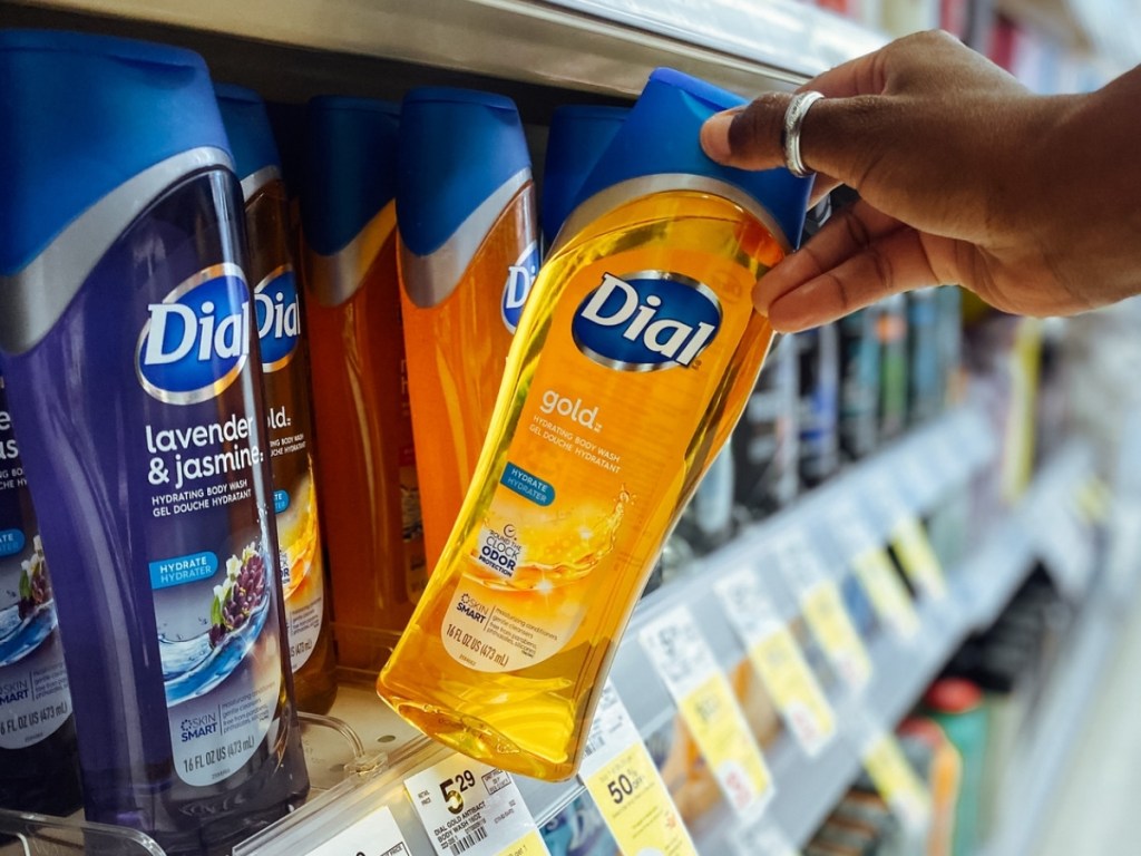 hand holding gold dial body wash in store