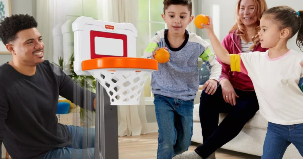 kids throwing basketball into toy net 