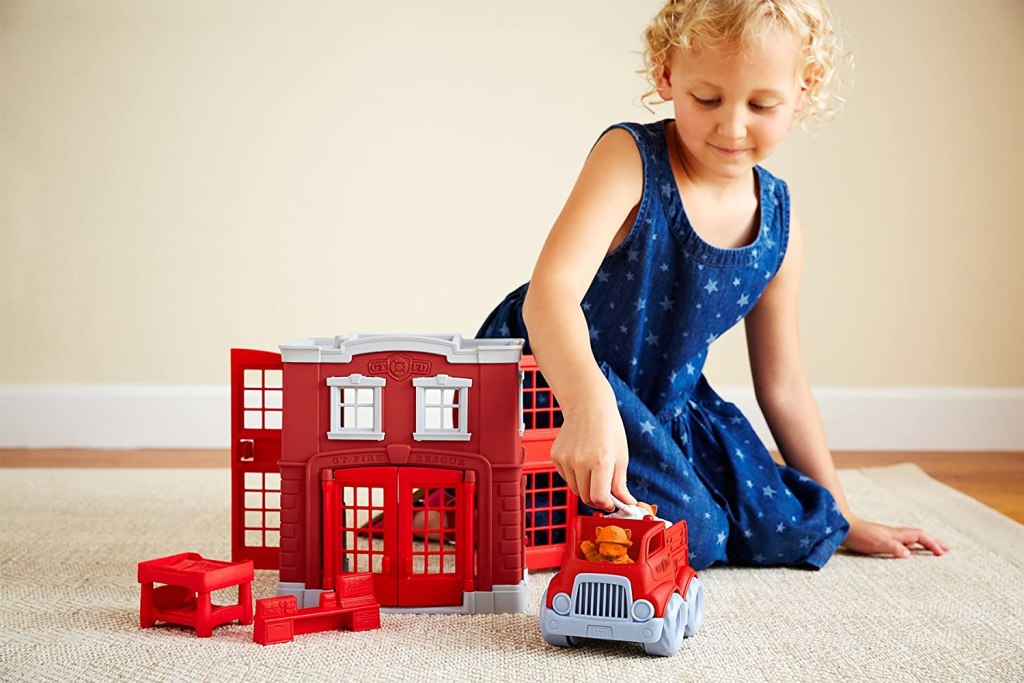 Girl Playing with Green Toys Fire Station