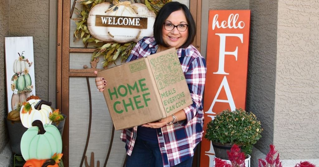 women on porch holding a Home Chef box