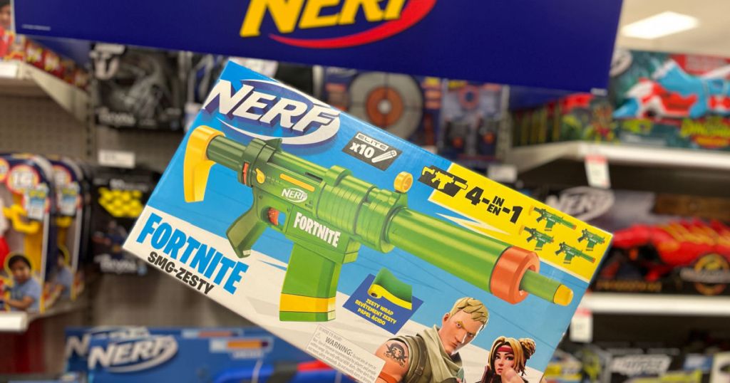 hand holding green toy gun 