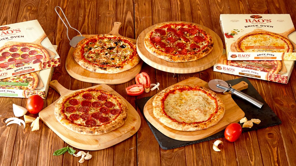 Rao's Frozen Pizzas and boxes on wood table and pizza paddle