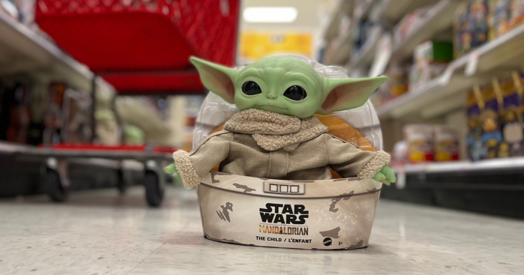 green toy doll in box 