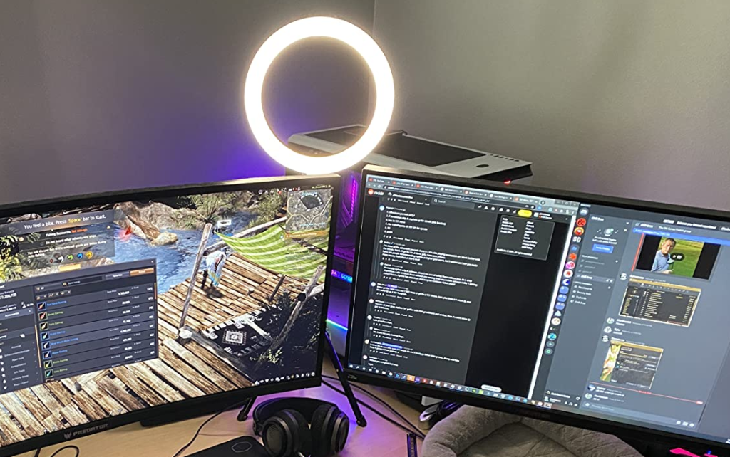 two computer monitors and a ring light