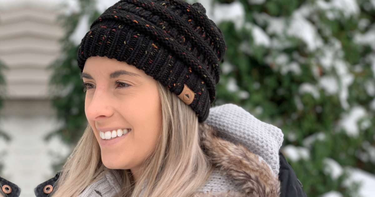 woman wearing a cable knit beanie