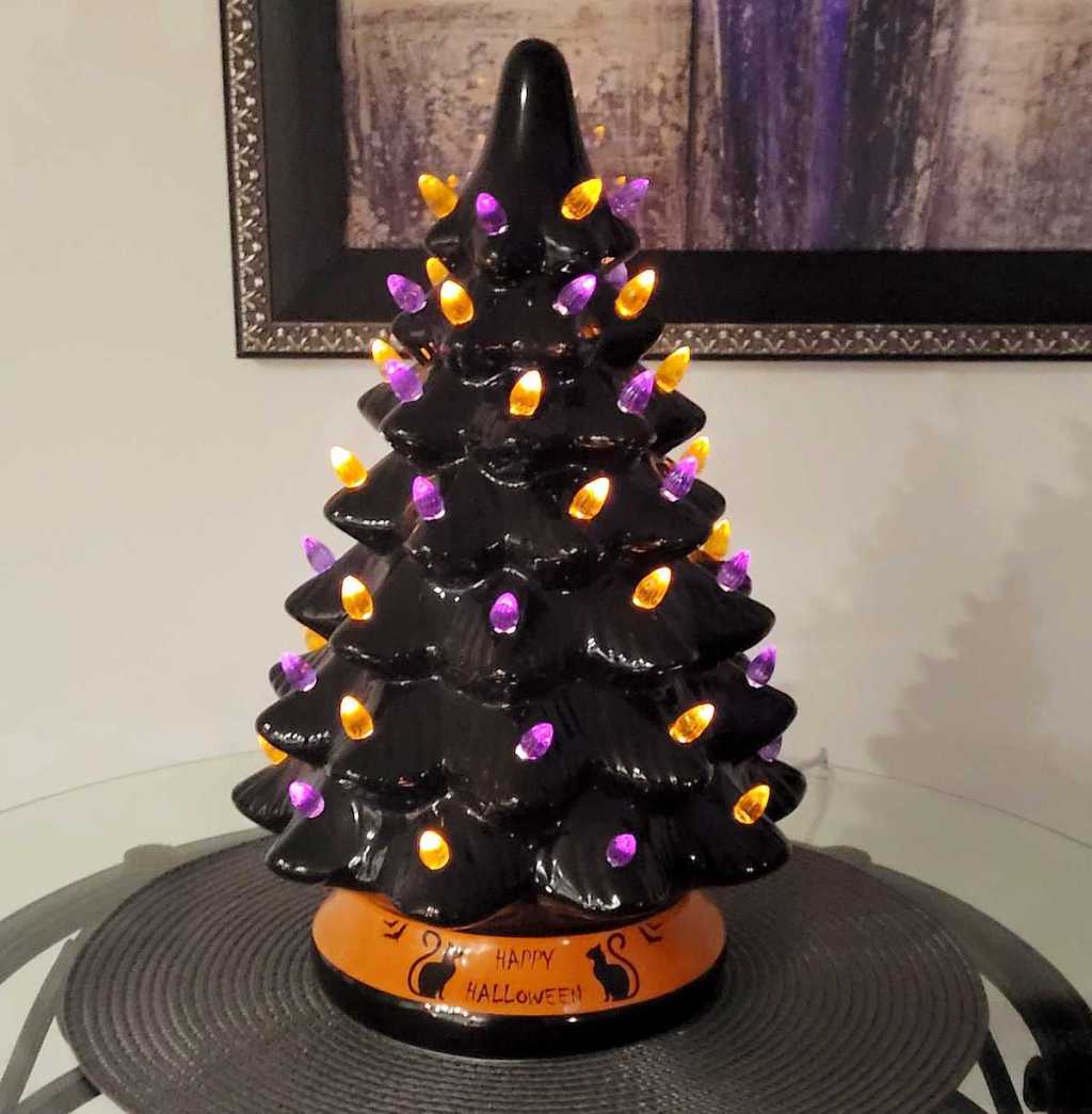 black halloween tree with lights on table