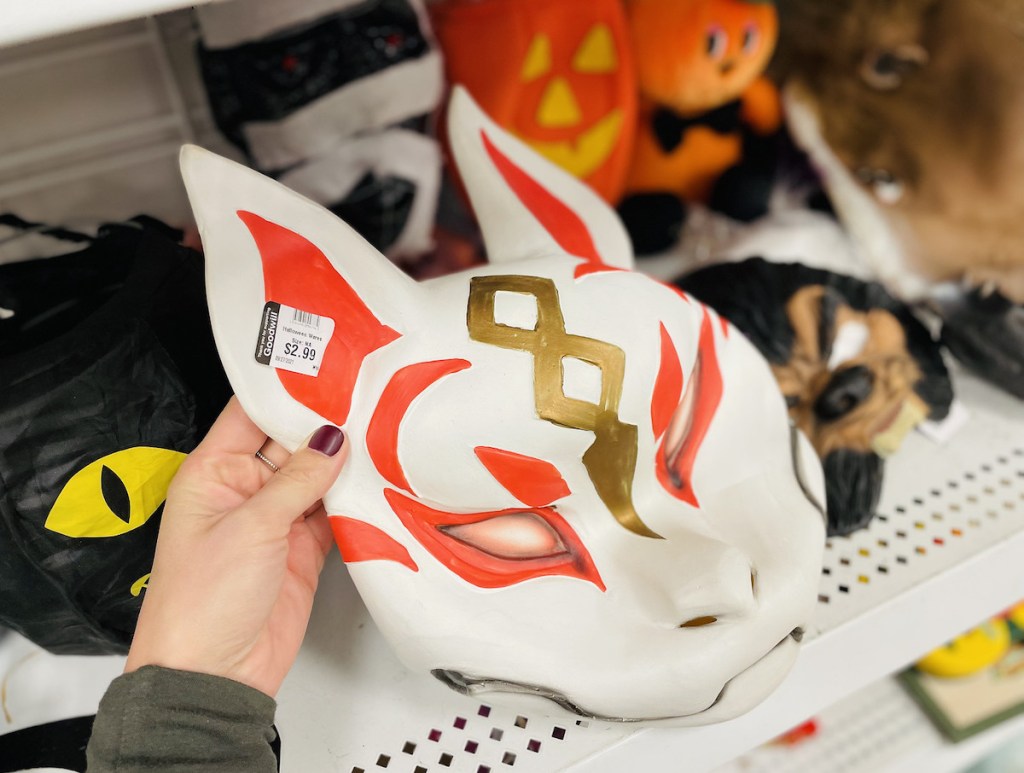 hand holding a thrift store fortnite mask