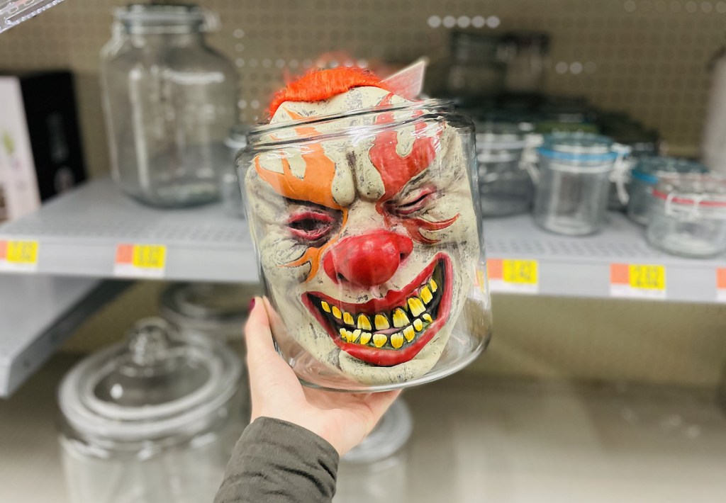 halloween clown mask in clear glass jar in walmart store aisle