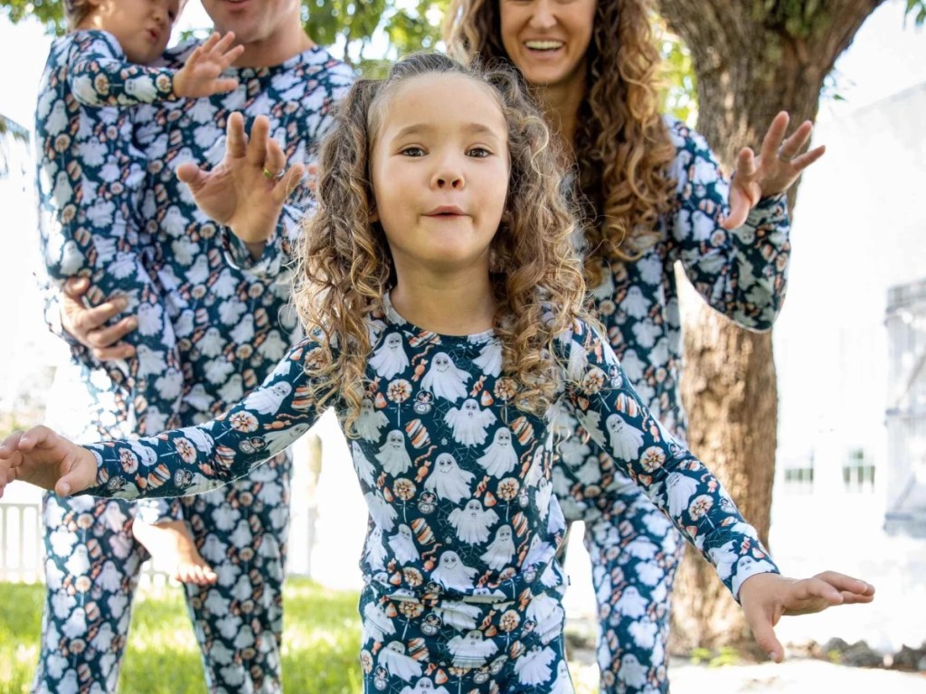 family wearing matching Halloween PJs