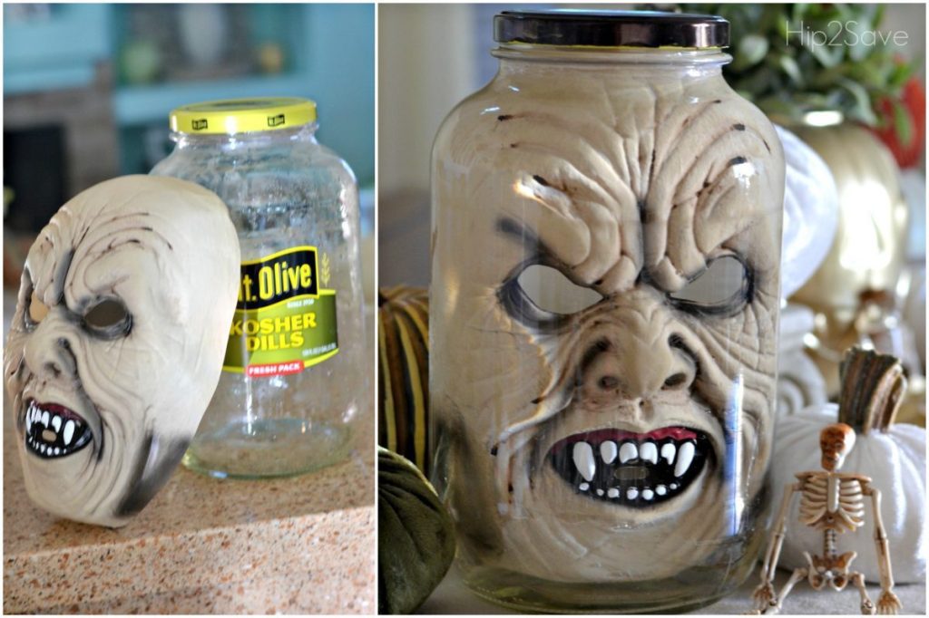 halloween face mask in pickle jar on kitchen counter