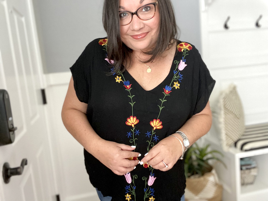 woman wearing black top with flowers on it