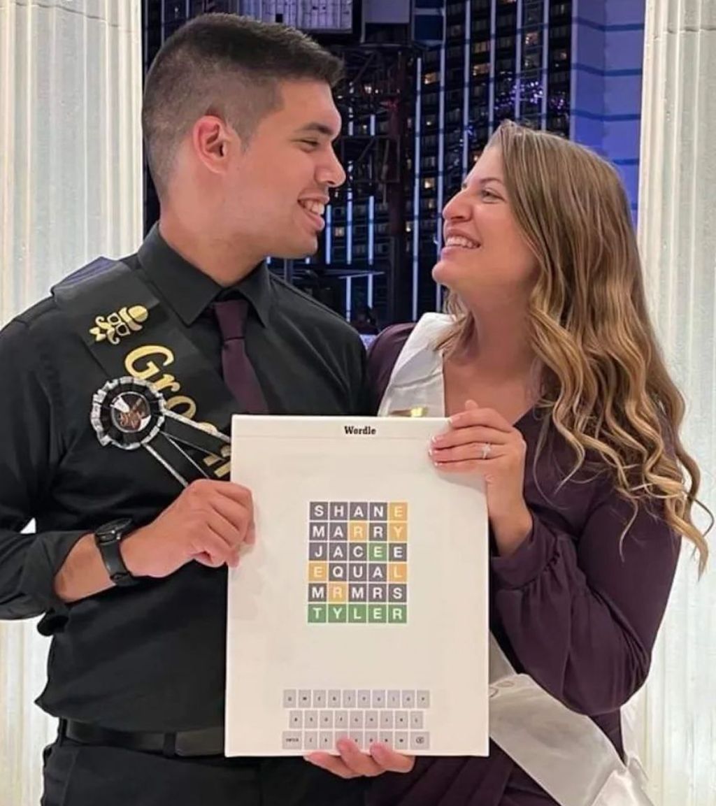 man and woman holding wordle print for engagement