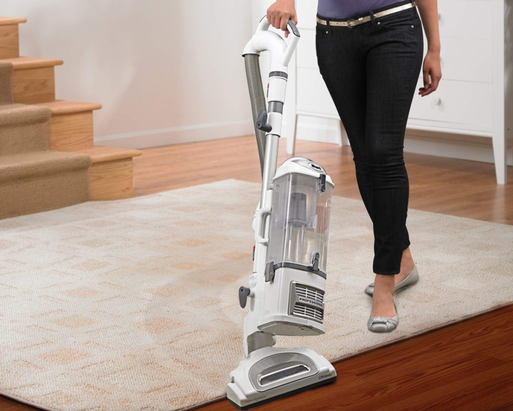 person using shark lift away vacuum