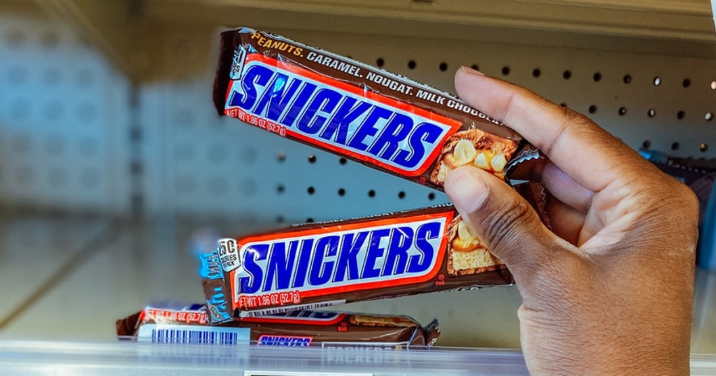 holding 2 Snickers bars