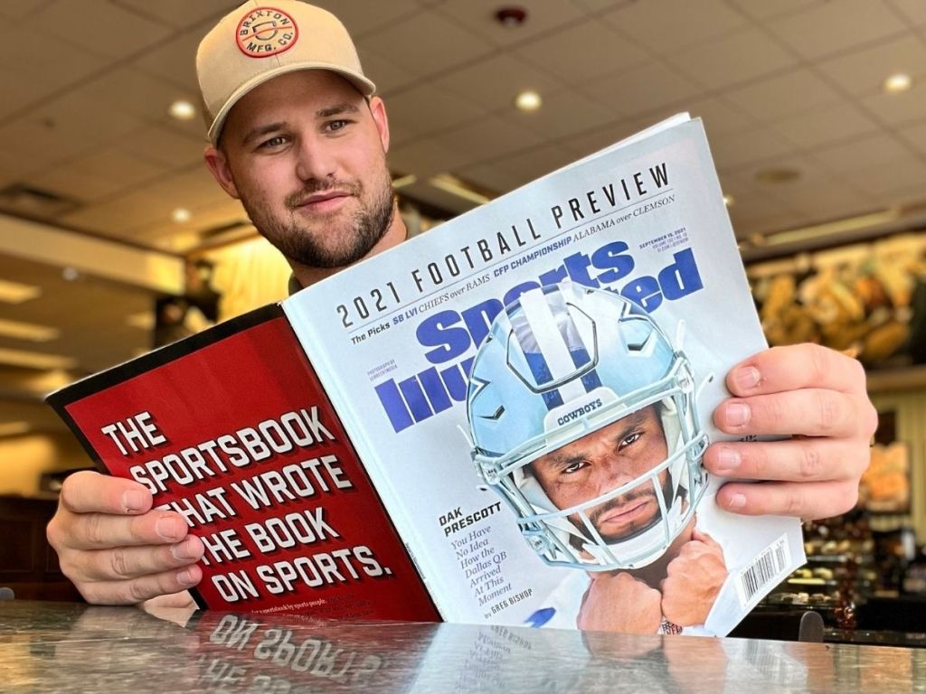 man reading Sports Illustrated magazine