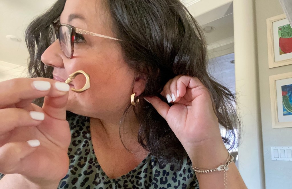 woman showing off gold hoop earrings on side of face