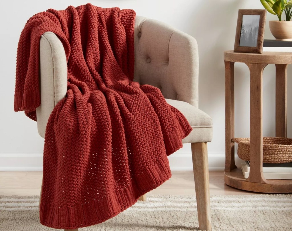 red blanket on beige chair
