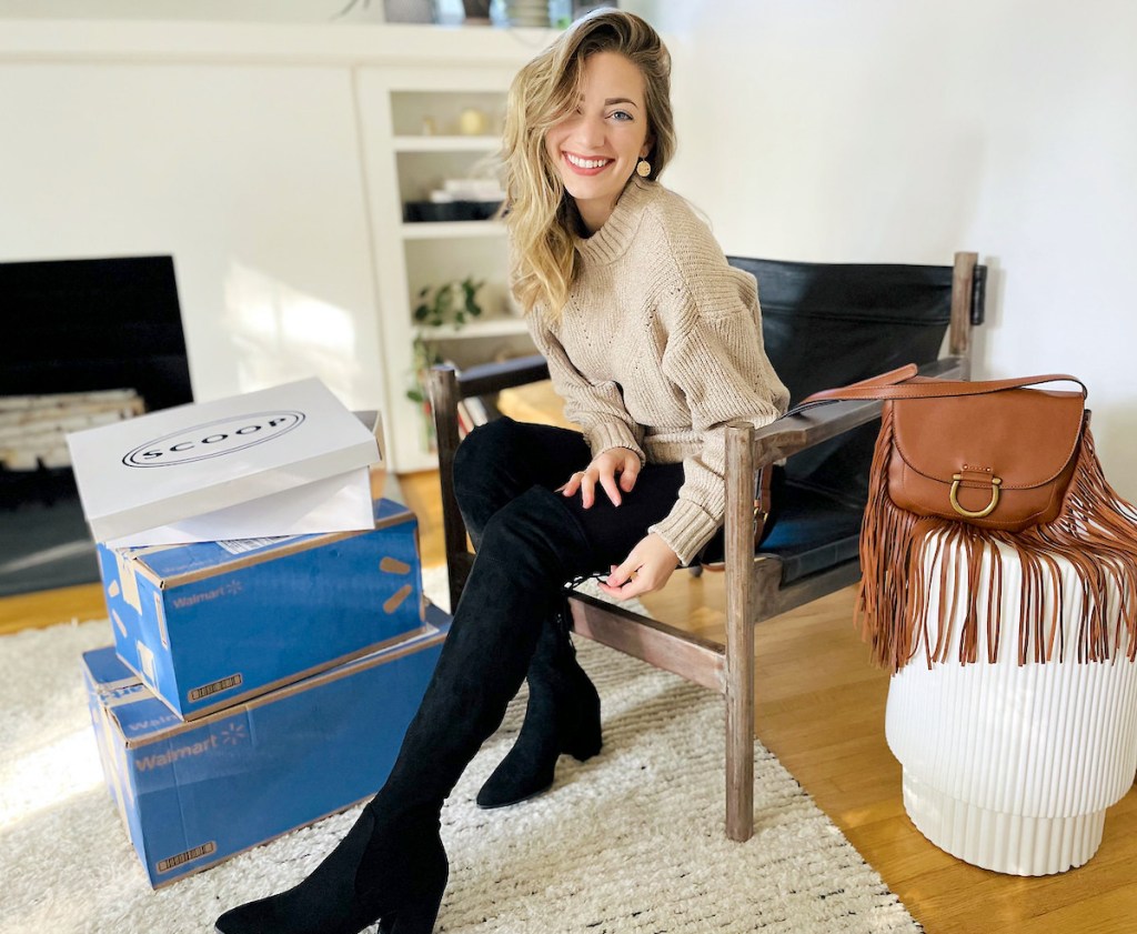 woman sitting on leather chair with walmart and scoop boxes and leather boho purse