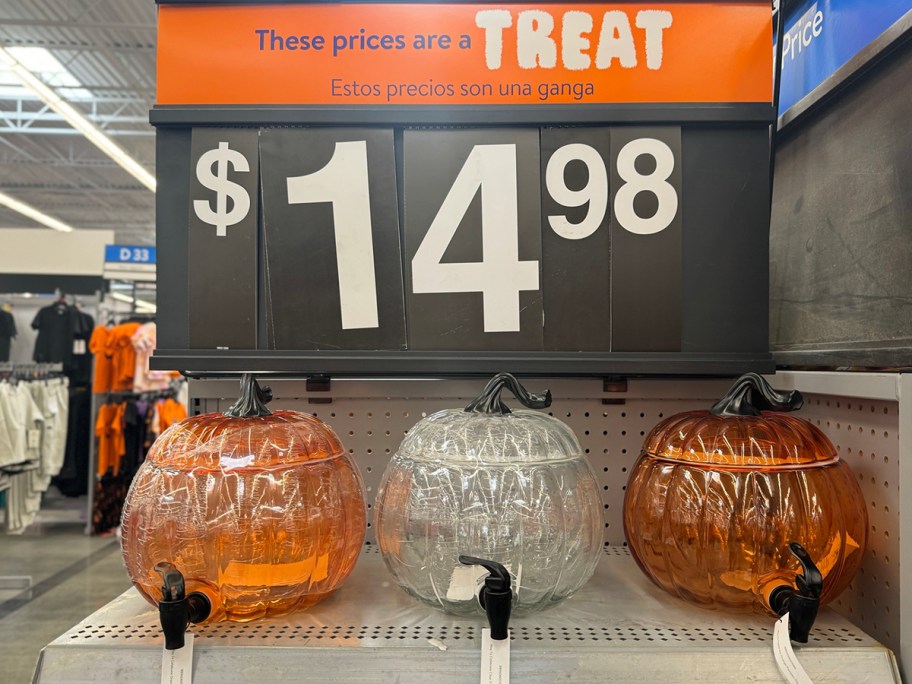 orange and clear glass pumpkin beverage dispensers on shelf at walmart