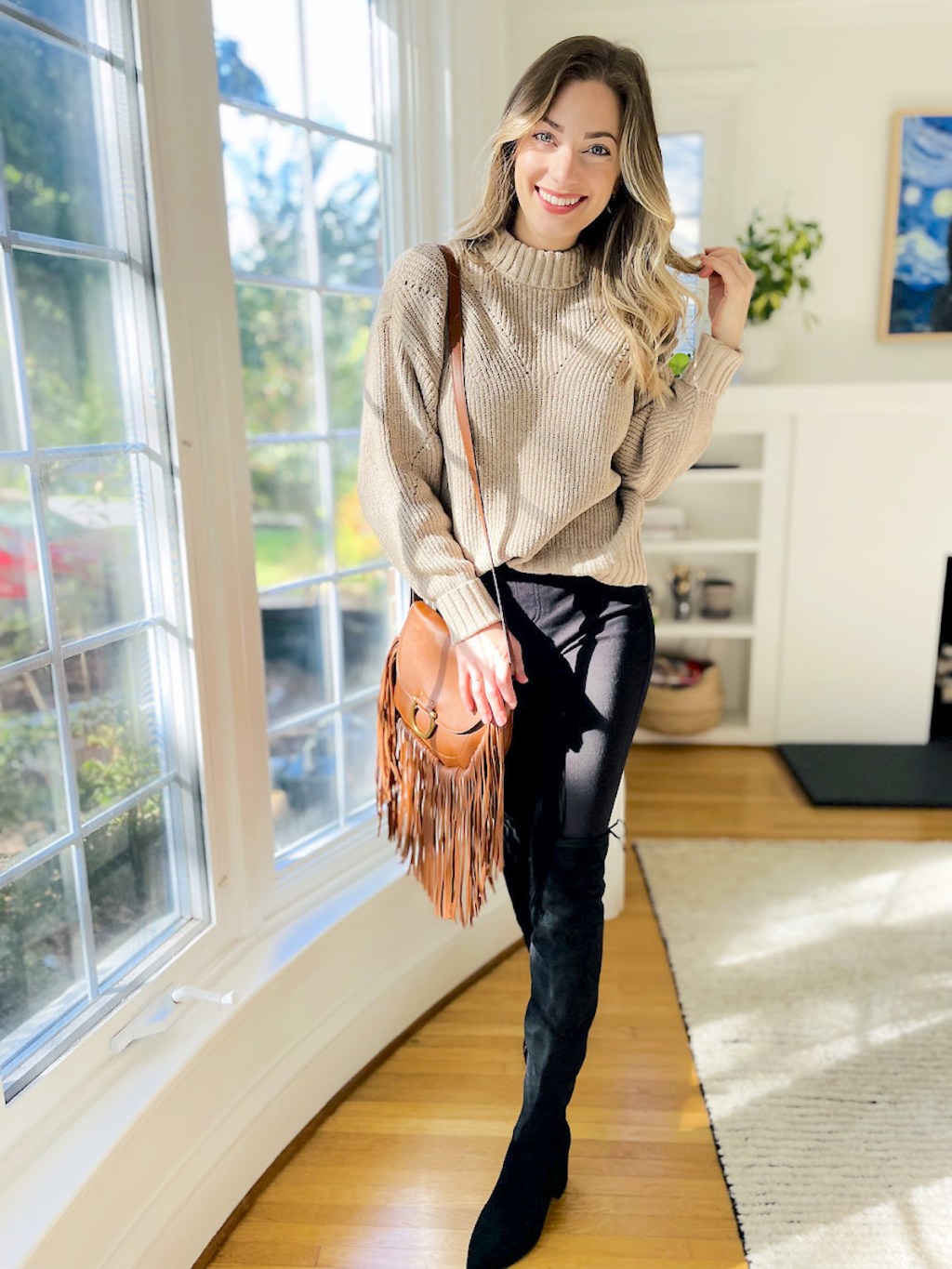 woman posing with walmart winter fashion outfit in front of large windows