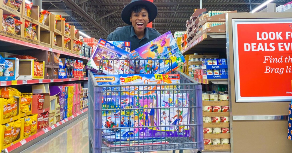 woman smiling by cart full of Advent calendars in the store