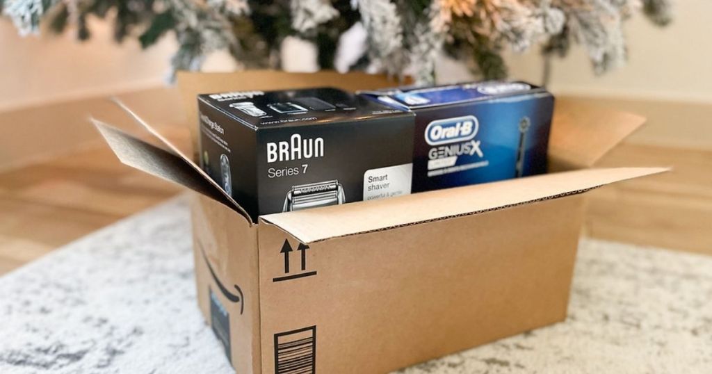 braun shaver and oral-b toothbrush in an Amazon box under the tree