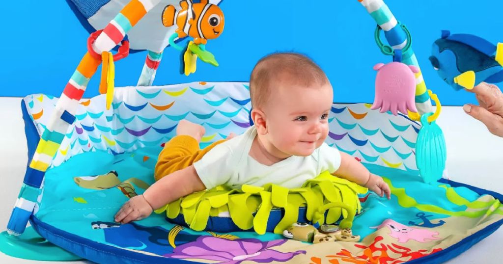 baby in ocean themed activity gym 